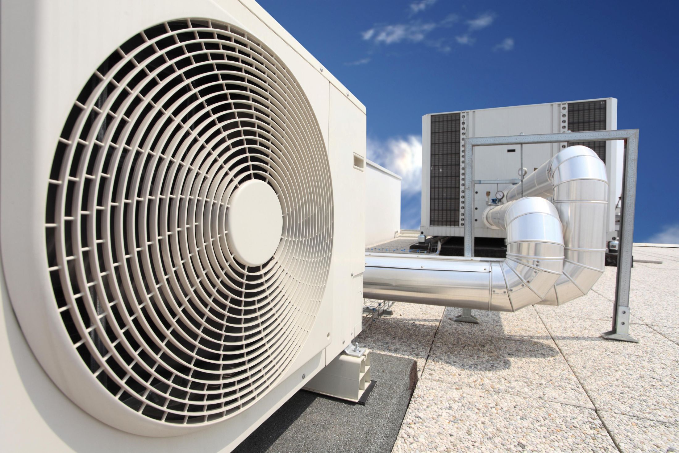 air-conditioning-units-on-a-rooftop-with-blue-sky-2026-01-09-11-21-00-utc